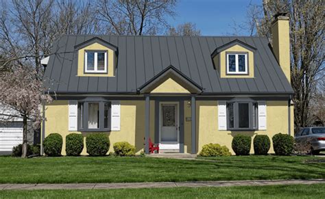 yellow house with black metal roof|yellow house with gray roof.